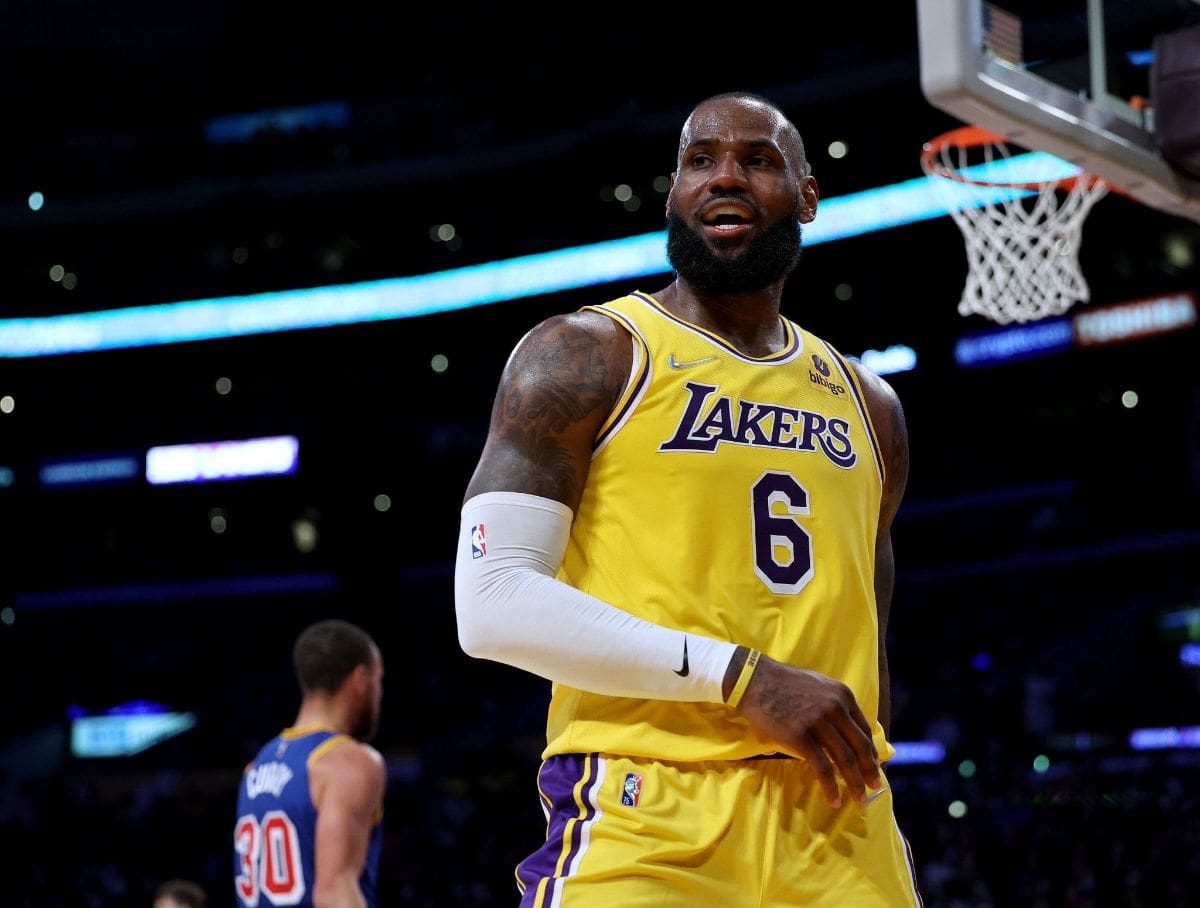 LeBron James wearing a yellow Los Angeles Lakers jersey, standing on the basketball court during a game.