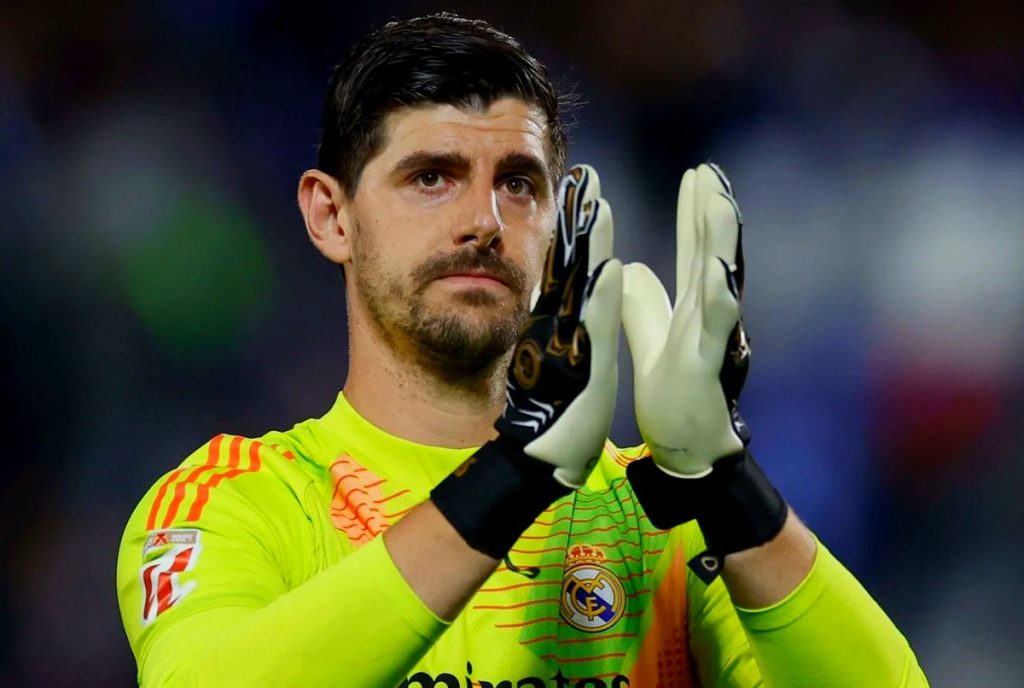 Thibaut Courtois playing for Real Madrid in a football match, displaying his goalkeeper abilities.
